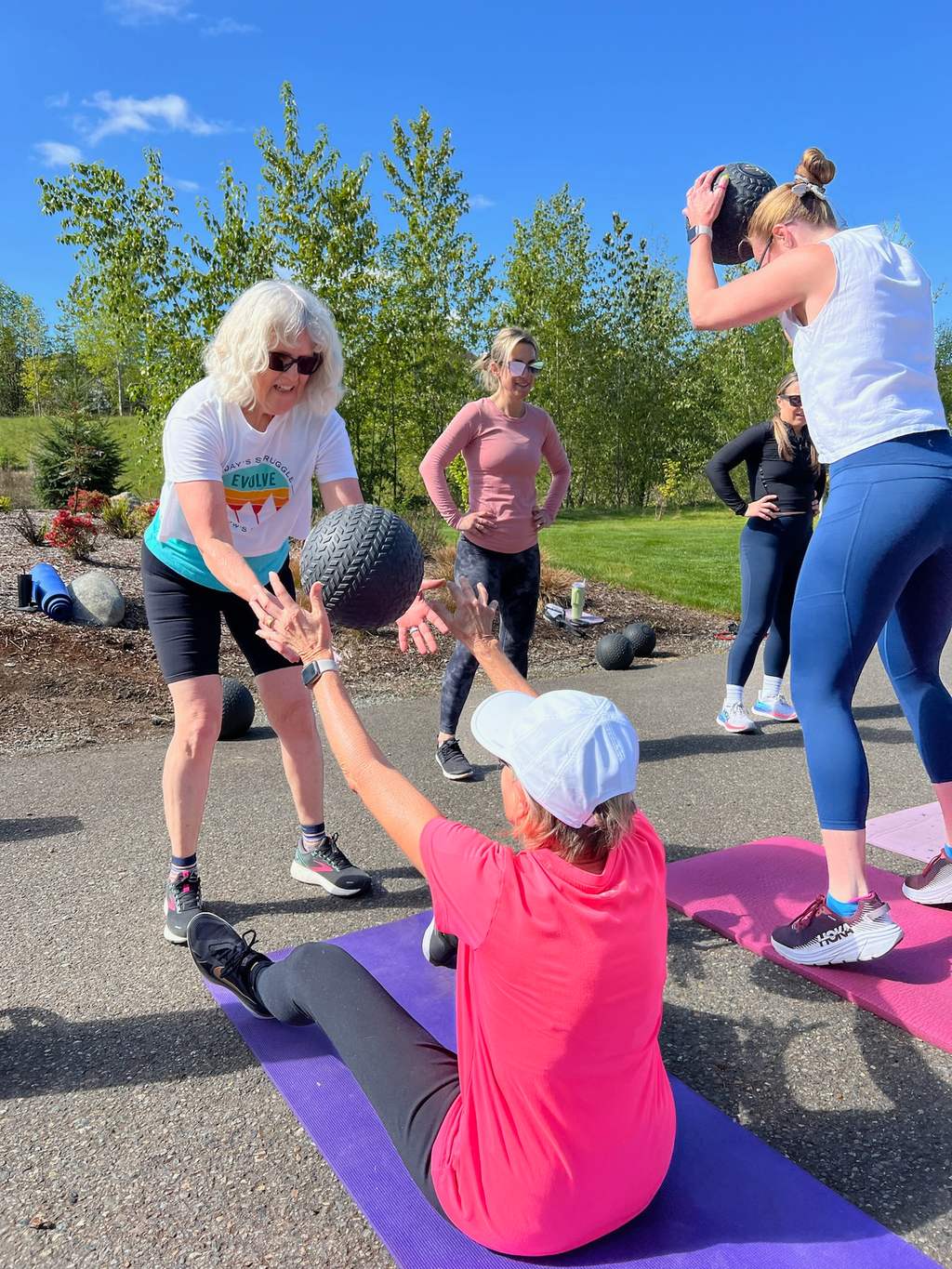 EVOLVE Strong Fitness members doing a team hands in after class